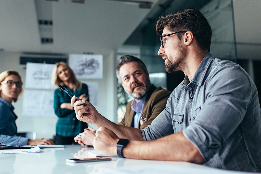 Executives discussing the strategic weight of tariffs and their impact on supply chain operations